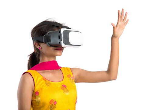 Indian traditional young girl holding and showing VR device, vr box, goggles, 3D Virtual Reality Glasses headset, Girl with Modern imaging Future technology on white background.