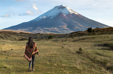 Woman walking towards a mountain