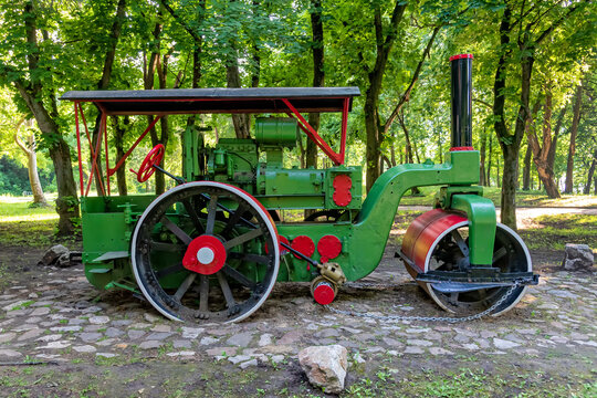 Old steamroller in red and green color. Antique Steamroller