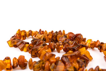 Baltic necklace made of Natural polished transparent honey luxury amber beads with inclusions on white. close up selective soft focus. Space for text