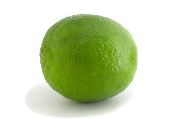 Green fresh lime isolated on white background. Citrus fruit in full focus.