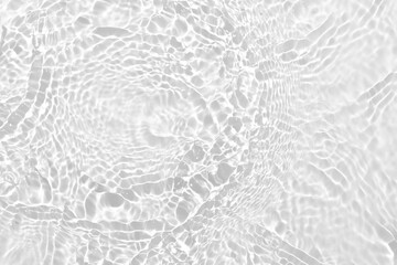 Desaturated transparent clear calm water surface texture with ripples, splashes Abstract nature background. White-grey water waves in sunlight Copy space Cosmetic moisturizer micellar toner emulsion