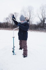 Children on ice fishing pose for the camera.