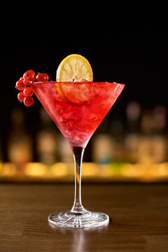 Closeup glass of cosmopolitan cocktail decorated with orange