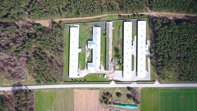 High angle drone video of large chicken farm in Wegrow County, Masovian Voivodeship of Poland