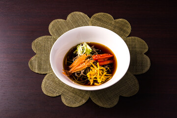 plate with cold soba over dark wooden table. Asian cuisine