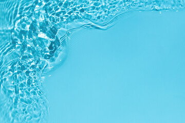 Transparent blue colored clear water surface texture with ripples, splashes and bubbles. Abstract...