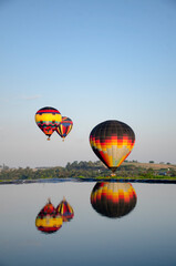 Fototapeta premium Hot air balloons flying, reflection in water