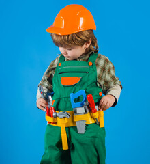 Little boy in builders uniform with tool belt. Tools for building. Kid repairman. Child game.