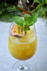 Cocktail with passion fruit and mango tropic background closep -