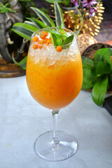 Homemade buckthorn (hippophae) cocktail, cold drink with fresh b
