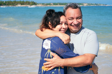 Fototapeta na wymiar Happy Senior Couple Hugging Together Outside Near Water