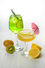 Two cocktails with decorations, fruits on white wood table texture. bar menu concept