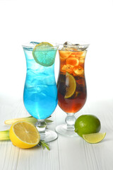 Two cocktails with decorations, fruits on white wood table texture. bar menu concept