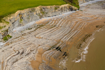 Aerial view of spectacular coastal limestone cliffs and ocean at Southerndown, Wales. UK