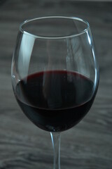 Red wine on wooden table on wooden background closeup