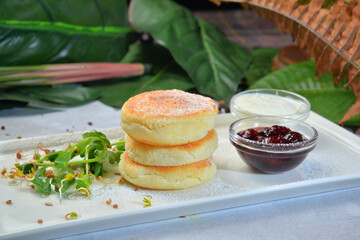 Cottage cheese pancakes powdered sugar, jam and yogurt,syrniki on decorated background - Image