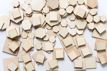 big pile of various sized wooden shapes in hexagonal and square form on white