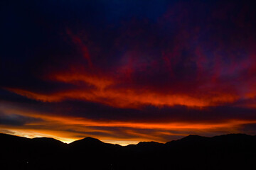 Sunrise over the mountains drawing the silhouettes with orange colors in Autlan Navarro 