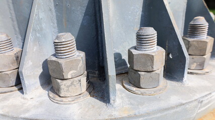 Nuts and screws on the metal base. close focus on the subject