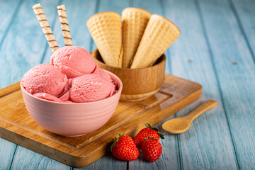 Bowl with strawberry ice cream balls.