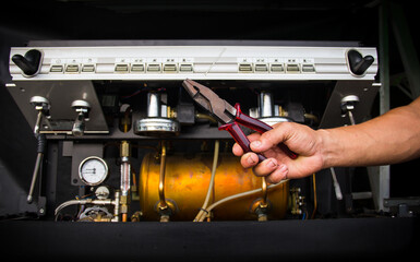 The master repairing broken coffee machine,disassembled coffee machine,Inside the coffee machine.