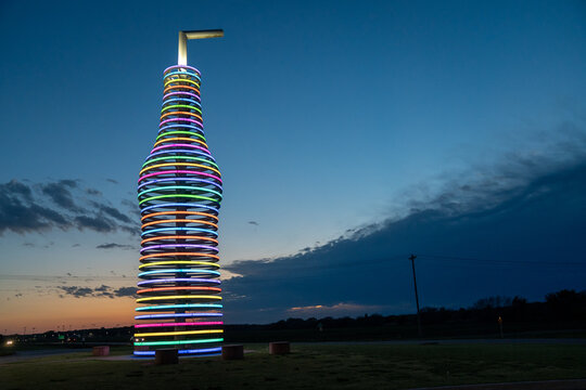 Arcadia, Oklaholma - May 5, 2021: Pops Route 66, home of the world&rsquo;s largest sculpture pop bottle. It lights up with neon lights at night