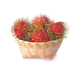 Fototapeta premium Rambutan in a bamboo basket on white background