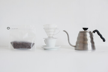 Set for coffee making with coffee beans in packaging isolated on white background