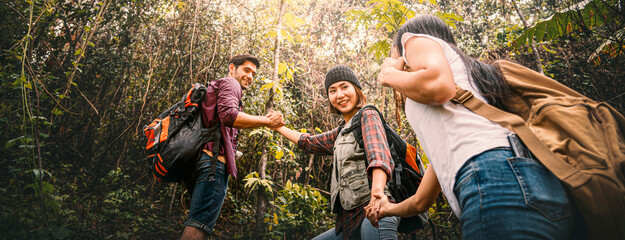 Tourists multiethnic friendship backpacking travel in the forest, happy freedom journey adventure...