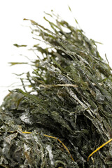dried, chopped, green seaweed on white background 