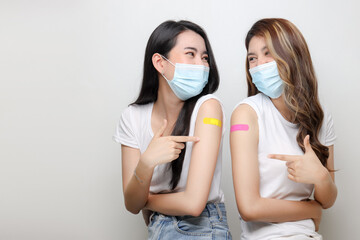 Smiling Of Asian Women Show Bandage On Arm. Happy Women Feel Good After Received Covid-19 Vaccine...