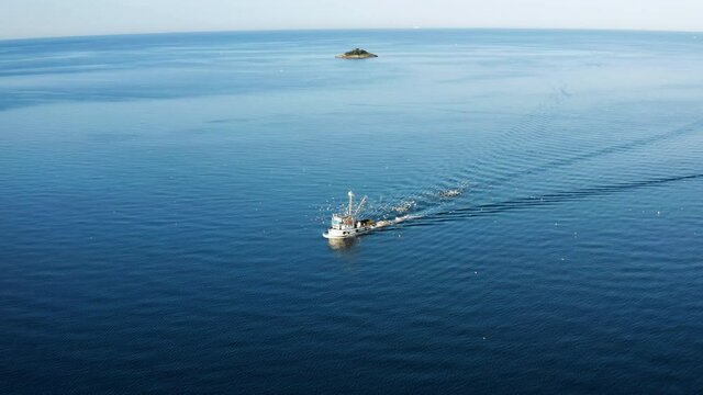 Blue Sea With Navigating Boat Near Rovinj Town In Istrian Peninsula, Croatia. - Aerial Shot