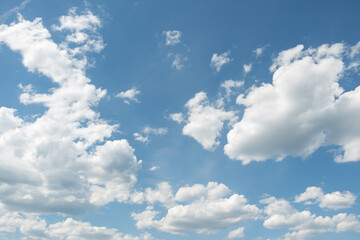 Naklejka na ściany i meble Blue sky with fluffy white clouds. Perfect natural sky background, wallpaper, greeting card