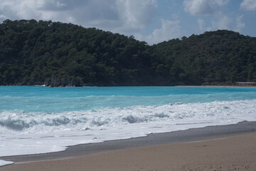 Blue waves roll onto the sandy shore