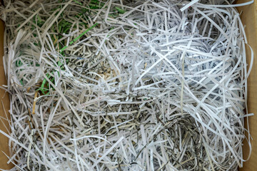 White shredded paper in a carboard box.