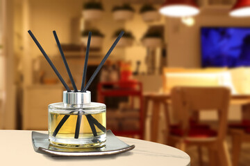 luxury aroma scented reed diffuser crystal bottle is used as room freshener and decoration items on white marble table in the nice modern living room to creat relax ambient in the evening