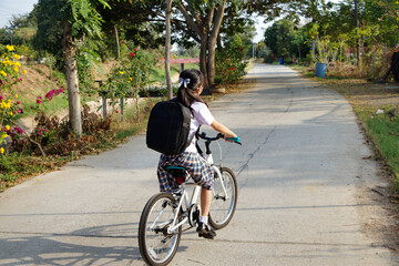 Asian girl wear mask biking to school. Back to school. New normal life style collection.