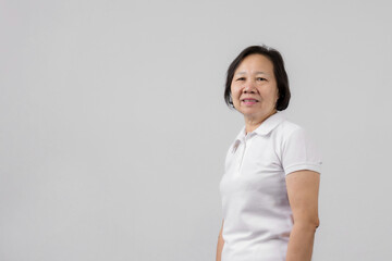 Happy Asian mother studio portrait on gray background