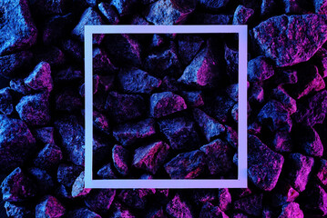 Trending space and galaxy background with stones white frame and neon lights. Fluorescent light of meteorite stones and minerals. © sergign