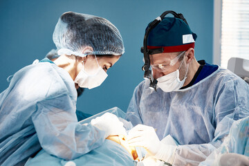 Doctors in hard work during a complex operation in the opera block, close-up, modern medicine.