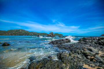 Sand beach among rocks on evening sunset. blue sky with a beautiful beach, playa