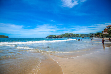 sunset on the beach with a huge rock, tropical beach paradise in Mexico