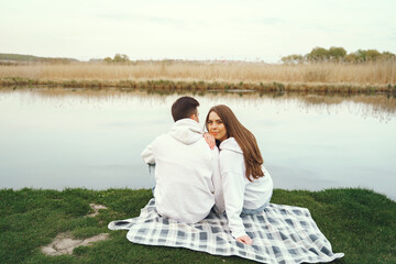 Beautiful couple spend time in a spring forest