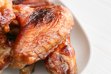 Plate with roasted chicken wings, closeup