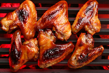 Roasted chicken wings cooking on grill
