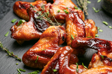 Roasted chicken wings on dark background