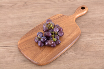 Fresh grapes on cutting board