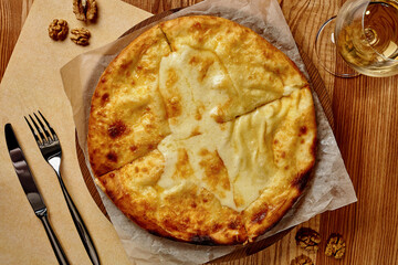 Top view of Imeretian khachapuri on wooden table