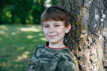 Portrait of preteen school kid boy. Beautiful happy child looking at the camera. Schoolboy smiling. Education concept.